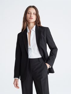 A tailored piece with a structured silhouette, this blazer is wrinkle-resistant and crafted with 4-way stretch for ease of movement. Detailed with crisp notch lapels and made with a single button closure. Finished with seaming details along the sleeves and back.  Material: 66% Polyester, 31% Viscose, 3% Elastane. Business Suits For Women Black, Calvin Klein Suits For Women, Black Blazer Outfit Work Business Professional Women, Crop Suit Outfit, Women Suit Aesthetic, Black Suit Outfits For Women, Suit Women Aesthetic, Black Blazer Outfit Work, Bustier Suit