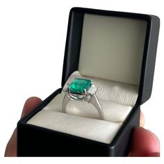 Description: Oversized Emerald Ring- Art-Déco Inspired Date: 2023 Provenance/origin: Handcrafted in Colombia Designer: SLÓ Fine Jewelry Weight: 7 gr Material: 18k white gold Stones: Emerald cut center stone (4,75 cts.) - Moderate oil treated (origin Muzo) & 2 baguette diamonds (0,78 cts.) FVVS2. Size: 10,99 mm Reports available: AGL report. Emerald Cocktail Ring, Emerald Cocktail, Colombian Emerald Ring, Art Deco Emerald Ring, Baguette Diamonds, Colombian Emeralds, Diamond Cocktail Rings, Gold Ring Sets, Modern Ring