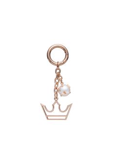 a gold key chain with a white bead hanging from it