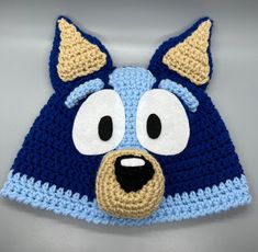 a crocheted hat with an animal face on it's front and sides