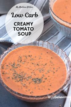 two bowls filled with creamy tomato soup on top of a table