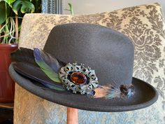 All of my creations are hand picked, hand crafted and one of a kind. My hats are inspired by the Victorian Era and art forms like Art Nouveau and Art Deco. All of my pieces bring a sense of elegance by intertwining the old and new. Each hat is hand picked and then dressed up with feathers, stone beads, a stone cabochon and a vintage cameo. No single hat is the same and all hats are designed to be their own. All the names are based off of my close friends or a song from one of my favorite musicia Formal Handmade Hat With Curved Brim, Handmade Formal Hat With Curved Brim, Adjustable Fedora For Formal Occasions, Custom Adjustable Fedora For Formal Occasions, Handmade Formal Hats, Handmade Adjustable Formal Hats, Adjustable Brimmed Victorian Top Hat, Adjustable Victorian Brimmed Top Hat, Adjustable Felt Hat With Short Brim For Costume