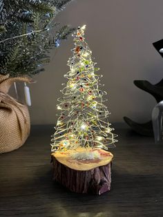 a small white christmas tree with lights on it