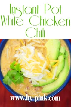 instant pot white chicken chili with avocado and shredded cheese in a blue bowl