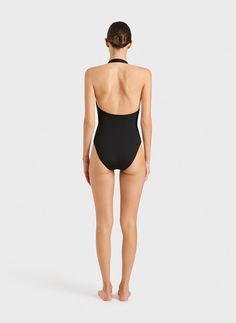 The Candice one piece in black is an elegant, feminine halterneck swimsuit that will never go out of style. The suit also works perfectly as a bodysuit worn under trousers or a skirt. A comfortable, wide, elasticated strap runs from under the shoulders and behind the neck. A scoop back reveals the shoulders. Self-lined in our ultra-soft Embodee™ fabric with high shaping power, Candice will become your go-to suit every summer. Luxury fabric sustainably made in Italy. Black One Piece Outfit, Australian Swimwear, Resort Wear Dresses, Summer Luxury, Halter Neck Swimsuit, Perfect Swimsuit, Luxury Fabric, Elegant Feminine, Swimwear Trends