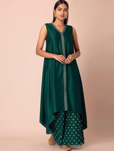 HAND CRAFTED KURTA DESCRIPTION * Green kurta * Lace detailing * Has V-neckline Sleeveless *A-Line shape Calf-length with high & low hem * Silk fabric *Package Contains:- Only One Kurta *Wash Care:- Hand Wash AVAILABLE IN 6 SIZES THEY ARE IN FOLLOWING MEASUREMENTS IN INCHES:- XS:- Bust-34/Waist-30/Shoulder-14/Length-46 S:- Bust-36/Waist-32/Shoulder-14.5/Length-46 M:- Bust-38/ Waist-34/Shoulder-15/Length-46 L:- Bust-40/Waist-36/Shoulder-15.5/Length-46 XL:- BUST-42/Waist-48/Shoulder-16/Length-46 XX Sleeveless Silk Dress For Eid, Unstitched Sleeveless Dress For Eid, Green Tunic Dress With Resham Embroidery, Sleeveless Green Kurta For Wedding, Traditional Green Sleeveless Dress, Green Silk Dress For Navratri, Sleeveless Fitted Kurta With Pallu, Green Sleeveless Kurta With Resham Embroidery, Green Sleeveless Resham Embroidered Kurta