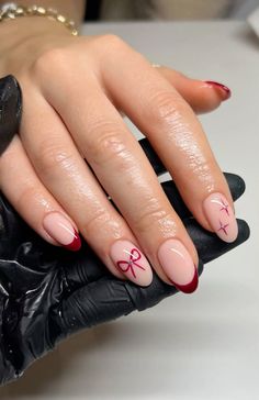 burgundy festive french tip nails with bows and stars #biab #gelnails #frenchtips #burgundynails #christmasnails #festivenails #nailinspo #christmasnailinspo #bows #stars #glitter Christmas Nails Red With Bow, Red French With Bow, Maroon Bow Nails, Christmas Nails Ribbon, Red Bow Nails Christmas, Pink Bow Christmas Nails, French Tip Nails With Bow Design, Holiday Nails With Bows, Bow Red Nails