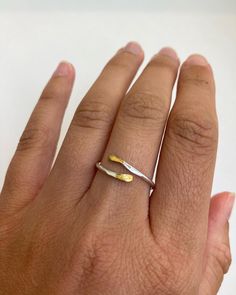 Introduce a touch of sophistication and edge to your jewelry collection with our Handcrafted Silver and Gold Plated Ring. This elegant piece is made from thick sterling silver round wire, carefully hammered and then gold plated on the tips for a beautiful silver and gold contrast. Simple and dainty, this ring is perfect for everyday wear or as a statement piece when paired with other silver, gold, or mixed metal jewelry. One of the best things about this ring is its versatility - it's a cuff ring, which means it's quite adjustable. The band is solid but can be pinched firmly to adjust the size. This means that you can wear it on any finger, and you don't have to worry about getting the perfect size. Just choose your size variation at checkout and we'll shape the ring to your specific size Everyday Hammered Open Ring, Unique Hammered Rings For Everyday Wear, Simple Hammered Ring Jewelry, Minimalist Hand Forged Open Midi Rings, Minimalist Hammered Jewelry With Open Band, Minimalist Hammered Open Band Jewelry, Delicate Hammered Ring Jewelry, Delicate Hammered Jewelry Ring, Unique Hammered Stackable Rings For Promise