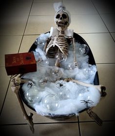 a skeleton sitting on top of a table filled with bubbles