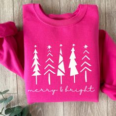 This Merry and Bright sweatshirt in Hot Pink is perfect for this holiday season whether you are cozying up with a good book or a holiday movie, going to a holiday function or getting your Christmas tree, this cozy sweatshirt is a great choice and makes a beautiful gift too. Check out the rest of our store here--> https://coastcountrydesign.etsy.com These garments are made from polyester and cotton. This combination helps designs come out looking fresh and beautiful. The collar is ribbed knit, so it retains its shape even after washing. There are no itchy side seams on these sweaters.  .: 50% cotton, 50% polyester (fiber content may vary for different colors) .: Medium-heavy fabric (8.0 oz/yd² (271 g/m .: Classic fit .: Tear-away label .: Runs true to size CARE INSTRUCTIONS:  * Turn garment Women’s Christmas Sweater, Christmas Sweatshirt Gift, Christmas Gift Sweatshirt With Relaxed Fit, Holiday Graphic Print Sweater, Holiday Cotton Sweatshirt, Christmas Sweater With Graphic Print And Relaxed Fit, Holiday Sweatshirt With Graphic Print, Relaxed Fit Christmas Sweater With Graphic Print, Holiday Graphic Print Sweatshirt