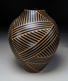 a black and gold vase sitting on top of a table