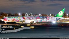 an evair airplane on the tarmac at night with its lights on and decorations painted all over it