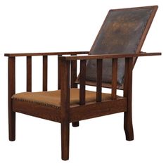 a wooden chair with a leather seat cushion