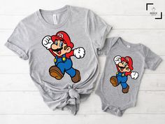 "Super Mario Shirt, Mario Shirt, Birthday Gift, Retro Game Shirt,Gift for Gamer,Video Game,Mario Party Shirt, Vintage Gamer Shirt Hello there! Welcome to our store SerixDesign, we are glad to see you here. The main purpose of our store is to make you happy. We see you as a friend, not just a customer. If you have any questions or would like to purchase a custom design, please contact us. We are sure you will like our designs. We will try our best to make you satisfied. HOW TO ORDER YOUR SHIRT? 1-) Please Check and Review All Photos. 2-) Choose your T-Shirt Size and T-Shirt Color from the drop-down menus. 3-) Choose your amount as much as you want. 4-) Click the ADD TO CART button. You can return or complete the checkout process to add more product colors for your family members. 5-) Please Family Matching Crew Neck Shirt With Cartoon Print, Character Print Crew Neck Top As Gift, Crew Neck Top With Character Print As Gift, Super Mom Shirt, Super Mario Shirt, Mario Shirt, Gift For Gamer, Disneyland Shirts, Xmas Tees