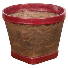 a red and brown basket sitting on top of a table