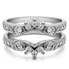 two wedding bands with diamonds on each band and the center diamond set in white gold