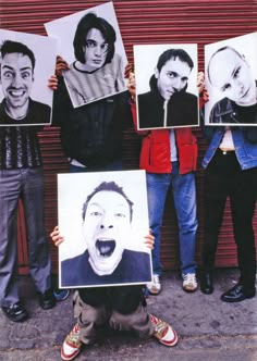 a group of people holding up pictures of themselves in front of a building with their mouths open