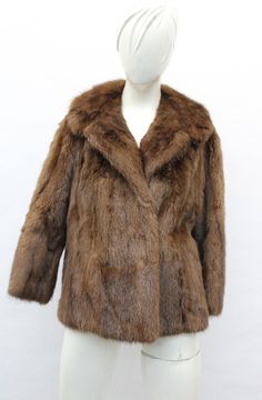 DESCRIPTION: BROWN MUSKRAT FUR JACKET!  THE COLLAR TYPE IS "NOTCH", IT CLOSES WITH HOOK & EYE CLOSURE AND HAS TWO SIDE POCKETS. THIS ITEM IS SCRAP: THE FUR IS DAMAGED BUT THE GOOD PART CAN BE USED FOR FUR ACCESSORY PROJECT! MEASUREMENTS:   SIZE: N/A LENGTH: 23"  SLEEVES: 25"; VERY SHORT LENGTH; MEASURED FROM THE SIDE OF THE NECK TO THE CUFF. b4462 Oliverfurs 9250 Parc Ave. #204, Montreal, Quebec, H2N 1Z2, Canada www.oliverfurswholesale.com oliver@oliverfurswholesale.com Toll free: 1-866-845-9997 Brown Fur Jacket, Raccoon Fur Coat, Fur Accessories, Sheepskin Jacket, Montreal Quebec, Brown Coat, Fur Vest, Hook Eye, Men's Coats And Jackets