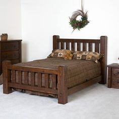 a wooden bed sitting in a bedroom next to two nightstands