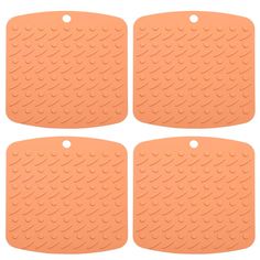 four pieces of orange rubber floor mats with holes on each side and circles in the middle