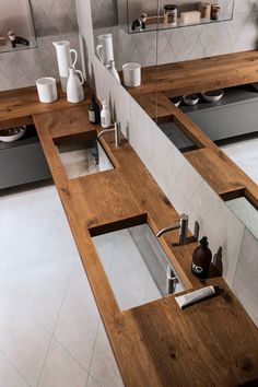 a bathroom with two sinks and mirrors in it