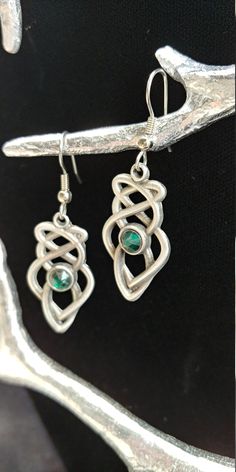 "Hand cast and hand finished out of lead-free Britannia Pewter. This pair of Celtic Knot earrings measures 1 1\\/4\" x 5\\/8\" and the earring post is surgical steel. Matching necklace is also available. I have more than one item in stock, if you require more, please contact me. History of Celtic Knots Celtic knots or Celtic interlace are ornamental patterns that first became associated with Celtic people in the early Celtic Church where they were used to decorate Bible. Monks used the Celtic kn Green Symbolic Nickel-free Jewelry, Symbolic Metal Jewelry With Matching Earrings, Silver Pewter Earrings As Gift, Silver Pewter Earrings For Gift, Hand Cast Silver Dangle Earrings, Silver Hand Cast Dangle Earrings, Adjustable Pewter Jewelry As Gift, Adjustable Hand Cast Earrings As Gift, Hand Cast Silver Drop Earrings