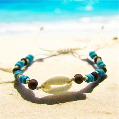 White waxed-cord beach bracelet/anklet with large cowrie shell, solid wood and turquoise beads.  Adjustable with slip knot. 🌊 🏊✅ Pool & ocean proof.  📦✅ Shipped FREE in the UK and dispatched on the SAME DAY where possible. 🎁✅ Gift wrap option available.  Visit our Etsy site to view other Ben's Beach jewellery --> https://www.etsy.com/uk/shop/BensBeach 🌐 Visit our main site --> https://bensbeach.com/ to view our wider selection and subscribe for updates (we do not spam) re new jewellery and Blue Wooden Beaded Bracelets For Beach, Vacation Cowrie Shell Strand Bracelets, Vacation Cowrie Shell Beaded Bracelets, Bohemian Shell Friendship Bracelets For Beach, Summer Beach Shell Friendship Bracelets, Bohemian Wooden Beaded Bracelets For Beach, Shell Strand Friendship Bracelets For Beach, Beach Shell Strand Friendship Bracelets, Turquoise Friendship Bracelets For Beach