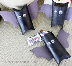 three bats made out of toilet paper and some candy