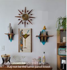 there are three wall hangings on the wall and one has a martini glass in it