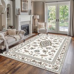 a living room filled with furniture and a large rug on top of a hard wood floor