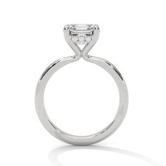 a white gold engagement ring with an oval cut diamond on the top and side stones