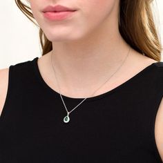 Perfect your evening attire with this tasteful fashion pendant. Fashioned in sterling silver, this regal look showcases a 7.0 x 5.0mm pear-shaped lab-created verdant-green emerald wrapped in a shimmering lab-created white sapphire-touched shadow-style frame. Buffed to a brilliant luster, this pendant suspends along an 18.0-inch rope chain that secures with a spring-ring clasp. Elegant Oval Pendant Gemstone Drop Necklace, Formal Pear Shaped Necklace With May Birthstone, Formal Pear-shaped May Birthstone Necklace, Formal Pear Shaped Necklace For May Birthstone, Elegant Teardrop Birthstone Drop Necklace, Elegant Teardrop Pendant Necklace For May Birthstone, Elegant Pear-shaped May Birthstone Necklace, Formal Teardrop Necklace With May Birthstone, Elegant Pear-shaped Birthstone Drop Necklace