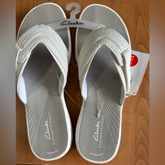 New Clark Sandals Woman’s Size 10 White Shoes Cloudsteppers Cushioned Comfortable New Cost $55 Smoke And Pet Free Home White Synthetic Slip-on Slippers, Comfortable White Slip-on Sandals, Synthetic Slippers With Ortholite Insole, White Non-slip Synthetic Slippers, White Synthetic Slippers For The Beach, White Beach Slippers With Textured Footbed, White Toe Post Comfortable Sandals, White Synthetic Beach Slippers, White Non-slip Closed Toe Sport Sandals