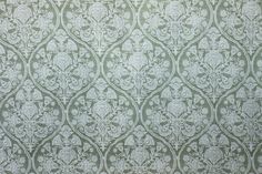 an old wallpaper with green and white designs