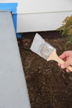 a person holding a paint brush in their hand