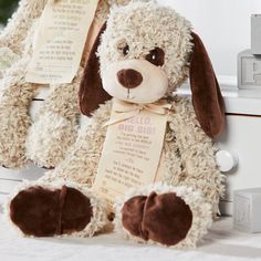 a stuffed dog sitting on top of a bed next to a white dresser with price tags