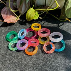 Custom resin ring made to order. Each piece is one of a kind!  If your desired color scheme isn't listed in the options or you would like 2+ colors, feel free to describe your vision in the personalization section. I currently offer four choices of ring styles: 1. Flat band 2. Bezeled band 3. Rounded band 4. Flat, bezeled, or rounded band with resin stone If choosing the style with a stone, you can specify your preferred color, opacity, shape, and size of the stone.  -- If you would like me to add one of the following materials to your ring (at no additional cost), please let me know which one: 1. Glitter (specify color and fine/coarse preference) 2. Gold/Silver/Copper/Rainbow leaf 3. Holographic foil (specify color) Trendy Multicolor Resin Rings, Clear Resin Rings, Handmade Multicolor Resin Rings, Trendy Plastic Rings As Gifts, Resin Stone, Ring Styles, Holographic Foil, Resin Ring, Kitchen Jars Storage