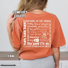 the back of a woman's orange shirt with words on it that read comfort colors something in the orange