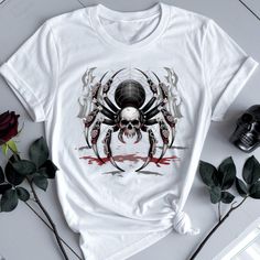 A spider descending from a web against a dark, moonlit background printed on a soft and lightweight unisex T-shirt. Perfect for anyone who enjoys a touch of spooky vibes and fits into the Halloween season. Product features - Made from 100% ring-spun cotton for durability and smoothness - Classic fit with crew neckline for versatile style - Fabric blends for different color options - No side seams for reduced fabric waste - Ethically grown and harvested US cotton Care instructions - Do not drycle White Gothic T-shirt For Streetwear, Gothic White T-shirt For Streetwear, Halloween Horror Skull Print T-shirt, Gothic Skull Print T-shirt For Halloween, White Grunge T-shirt For Halloween, White Gothic Crew Neck Top, White Gothic Top For Streetwear, Gothic Halloween T-shirt With Letter Print, Gothic White T-shirt For Halloween