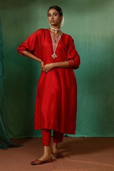 Red silk kurta with contrast thread, zari, bead, sequin embroidered yoke and dolman sleeve cuffs. Paired with straight pant and inner slip.
Components: 3
Pattern: Embroidered
Type Of Work: Sequin, Zari, Thread and Bead Work
Neckline: Kurta: Notched Round Neck
Sleeve Type: Kurta: Dolman Sleeves
Fabric: Silk
Color: Red
Other Details: 
Side high slits on kurta
Beaded hem details
Kurta Closure: Back loop button
Occasion: Mehendi and Haldi,Puja - Aza Fashions India Trip, Maroon Pants, Red Kurta, Traditional Indian Outfits, Silk Kurta, Silk Tunic, Boutique Dress Designs, Boutique Dress, Red Sequin