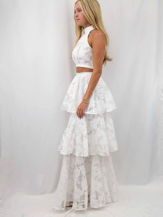 Elevate your formal wardrobe with this exquisite white layered two piece set, perfect for bridal occasions and elegant events. Featuring a sophisticated high halter neck with a zipper closure at the back, this set is crafted from a delicate, floral-patterned fabric that exudes romance and grace. The fitted bodice reveals a subtle midriff before flowing into a voluminous, tiered skirt with cascading ruffled layers that create a dreamy, ethereal silhouette. Each tier is intricately detailed, showc Bridal Rehearsal Dinner Outfit, Black Date Night Outfit, White Two Piece Set, White Two Piece, Black Dating, Nashville Style, Rehearsal Dinner Dresses, Denim Jacket With Dress, Bride Accessories