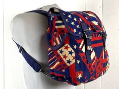 "Vintage 1960s or 70s red white and blue American flag cotton canvas bag, backpack, book bag. Op art styling. Has adjustable shoulder straps, double buckle flap, outside side pocket, one main compartment with a large flat inner pocket.  Bag measures about 13\" X 13\" X 6\" In very good condition." Vintage Canvas Shoulder Bag Backpack, Vintage Canvas Satchel Backpack, Vintage Canvas Backpack With Adjustable Strap, Vintage Canvas Bag With Adjustable Strap For School, Vintage Backpack Shoulder Bag For School, Vintage School Backpack Shoulder Bag, Retro Canvas Backpack, Retro Canvas Shoulder Bag, Retro Red School Shoulder Bag