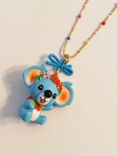 A 🐨 Bear ! How Adorable ! 🐨 How Cute ! 🐨 You need this Awesome Colorful Bear in your life to enhance your Mood and Day ! Just look how Cheerful and Happy this Awesome Koala Bear looks ! Share some Cheer with the Special people that are dear to your 💙  This Adorable Blue Koala is made of light weight Resin and it has been adorned with Bright Beautiful Flowers. *1 1/4 inches long and wide* (Medium Size Charm) What Girl doesn't love Flowers ? It's hanging on a matching 16 inch adjustable Bright Small Beaded Necklace, Bear Necklace, Bear Pendant, Necklace Box, Colourful Necklace, Special People, Koala Bear, Love Flowers, Beaded Chain