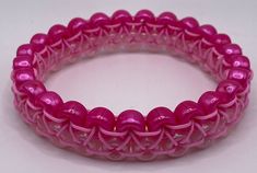 the pink bracelet is made from plastic beads