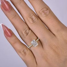 a woman's hand with a diamond ring on it