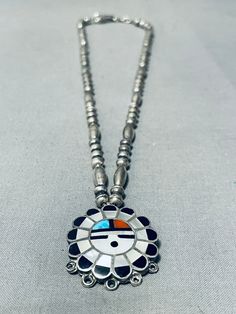 MAKE US AN OFFER BY CLICKING THE "MESSAGE SELLER" Button- Here we have an impressive vintage Zuni silver necklace.  This silver bead necklace has the stunning 1-?" round sunface pendant that's beautifully created of inlay stones of turquoise, coral, mother of pearl and jet!  Sweet! Sterling silver, marked. The length of the necklace measures around 20". Sturdy 26 grams.  Make Us an Offer- Due to the high demand of our items, many pieces sell quite fast. The most frequent email we receive are fro Handmade Vintage Round Turquoise Necklace, Vintage Sterling Silver Turquoise Necklace, Vintage Sterling Silver Turquoise Necklace In Silver, Nickel Free Sterling Silver Vintage Turquoise Necklace, Handmade Vintage Turquoise Necklace With Round Pendant, Vintage Turquoise Round Necklace For Gift, Vintage Round Turquoise Necklace For Gift, Vintage Round Turquoise Necklace Gift, Vintage Turquoise Pendant Necklace