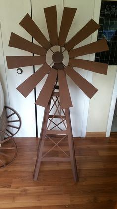 a wooden windmill sitting on top of a hard wood floor