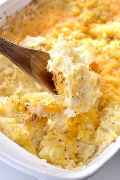 a wooden spoon scooping out some food from a casserole dish