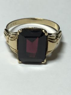 Great representation from the famous jeweler Ostby Barton. Mid century marked 10k OB. The garnet is prong set measuring 8x10mm. There is some surface scratching on the table but not a distraction to this ring. It weighs 2.4 grams. It is a ring size 5.75. It could be sized but there would be a chance of losing the hallmark. Any questions, please ask. January Birthstone Rings, Baby Rings, Gold Sign, Hand Ring, Garnet Jewelry, January Birthstone, Garnet Rings, Moonstone Ring, Birthstone Ring