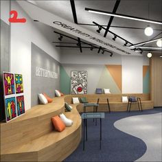 the interior of a modern office with curved seating and colorful artwork on the wall behind the desks